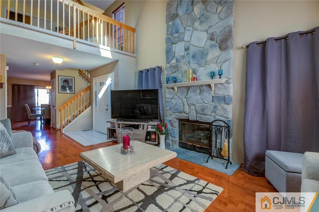 170 Salem Road North Brunswick, NJ 08902 - Photo 8 of 25 a living room with furniture a flat screen tv and a fireplace