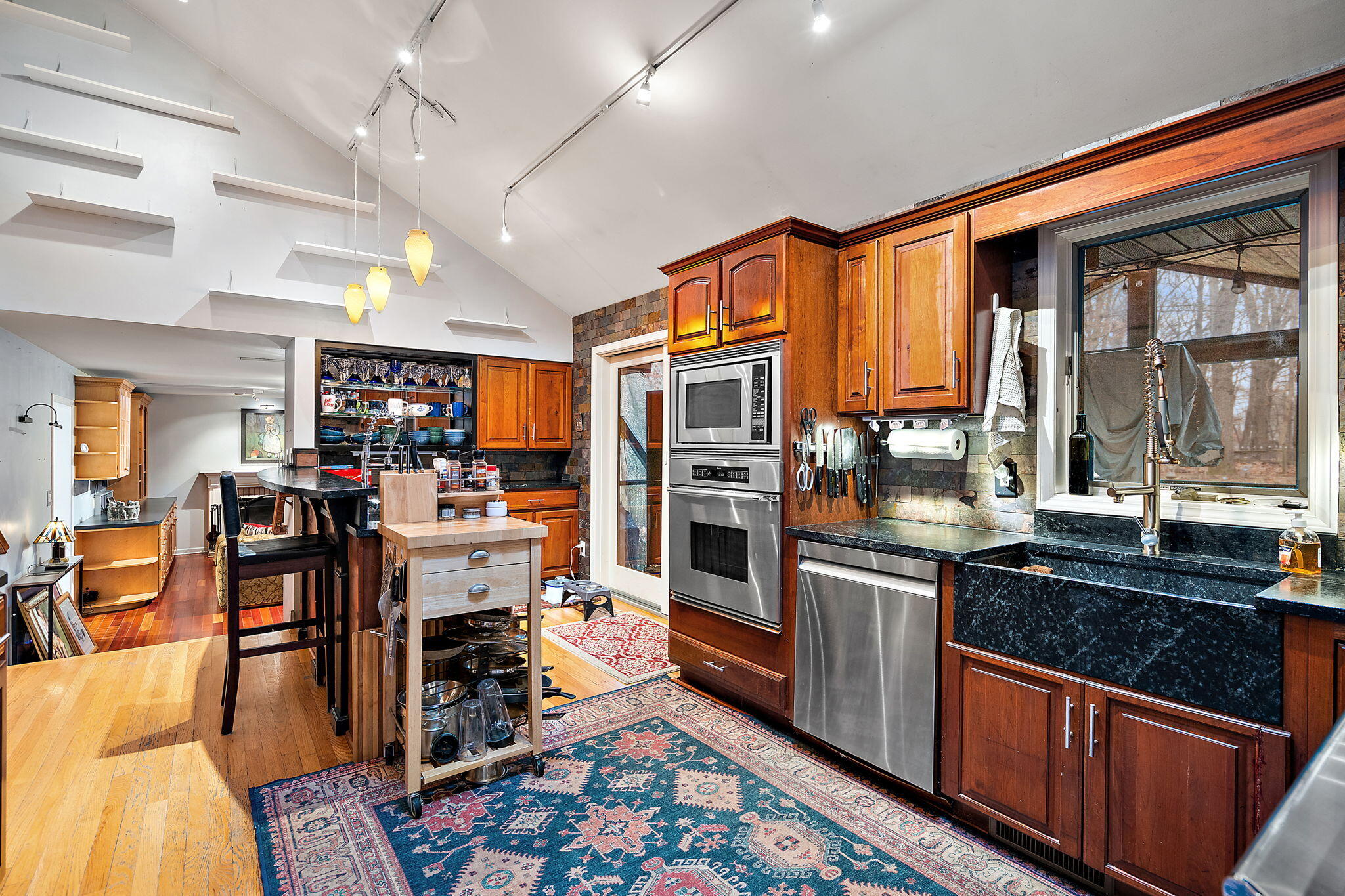 733 South Indiana Avenue Griffith, IN 46319 - Photo 12 of 48 a kitchen with stainless steel appliances granite countertop a refrigerator and wooden cabinets