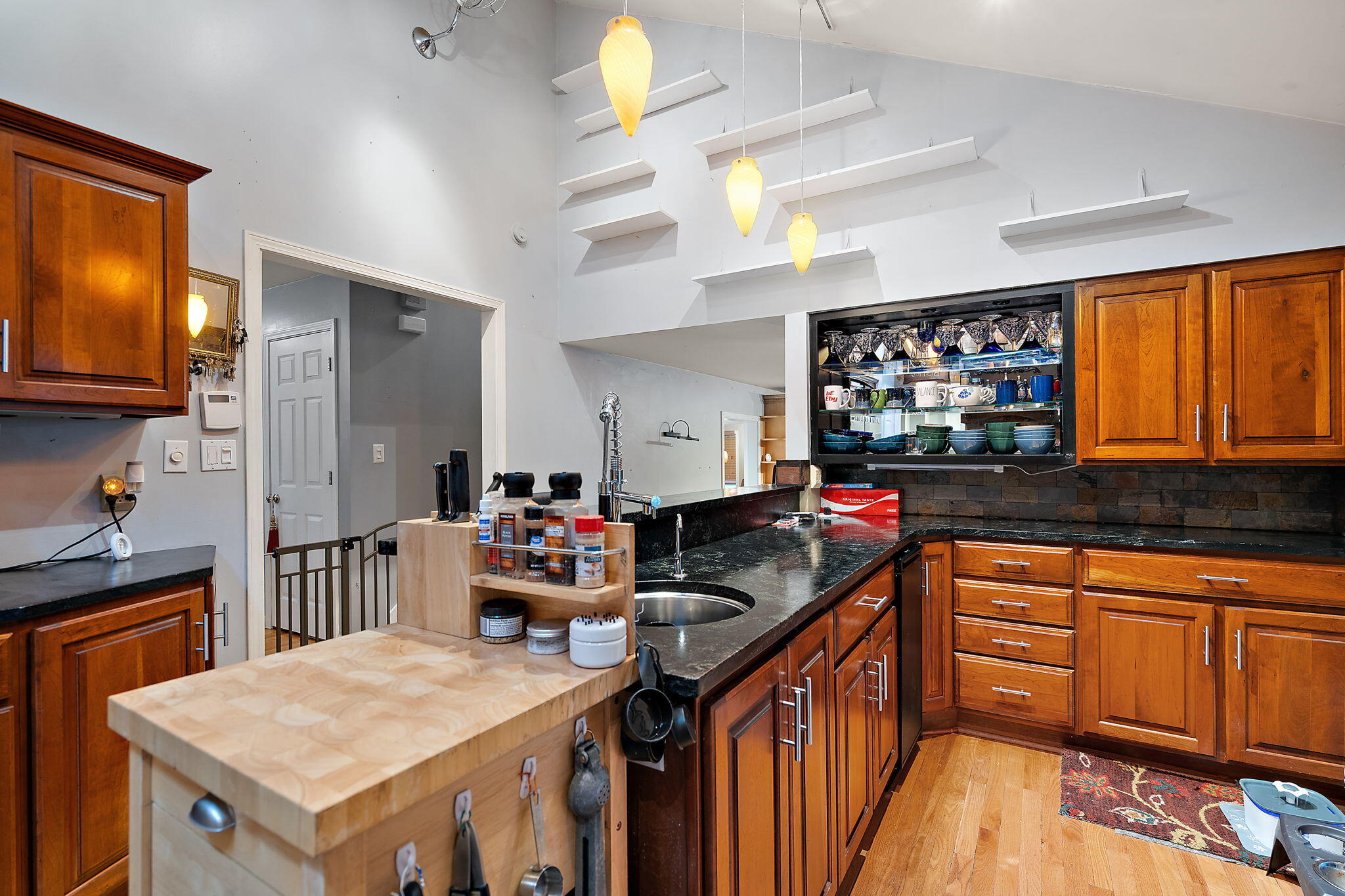 733 South Indiana Avenue Griffith, IN 46319 - Photo 14 of 48 a kitchen with a stove a sink a refrigerator and wooden cabinets