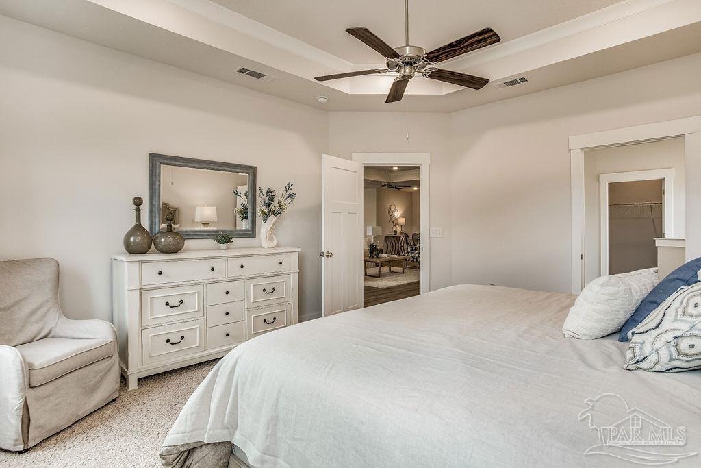 7757 Saddlebrook Avenue Pace, FL 32571 - Photo 21 of 28 a bedroom with a bed a couches and dresser