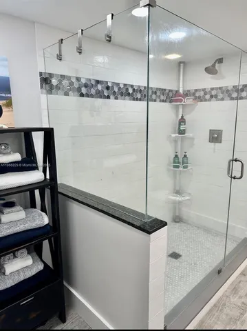 a bathroom with a shower and a sink