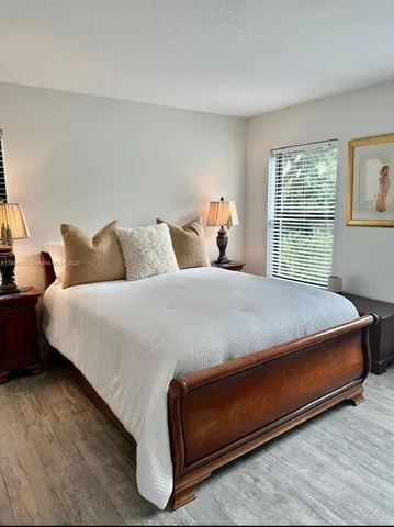 a bed sitting in a bedroom next to a window