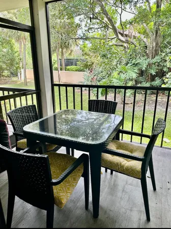 a view of a balcony with furniture