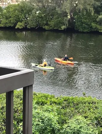 an aerial view of a house with a yard and a lake view