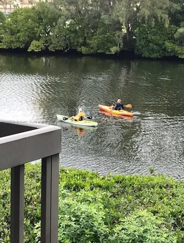 an aerial view of a house with a yard and a lake view
