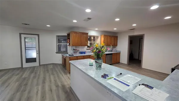 a view of a chairs and table in the backyard