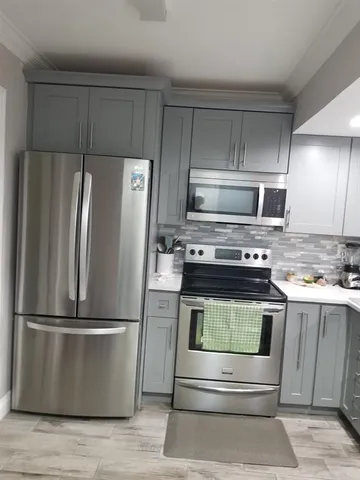 a kitchen with appliances and a refrigerator