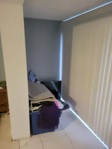 a room with a bed and television