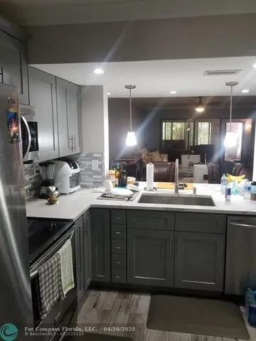 a kitchen with a sink and cabinets