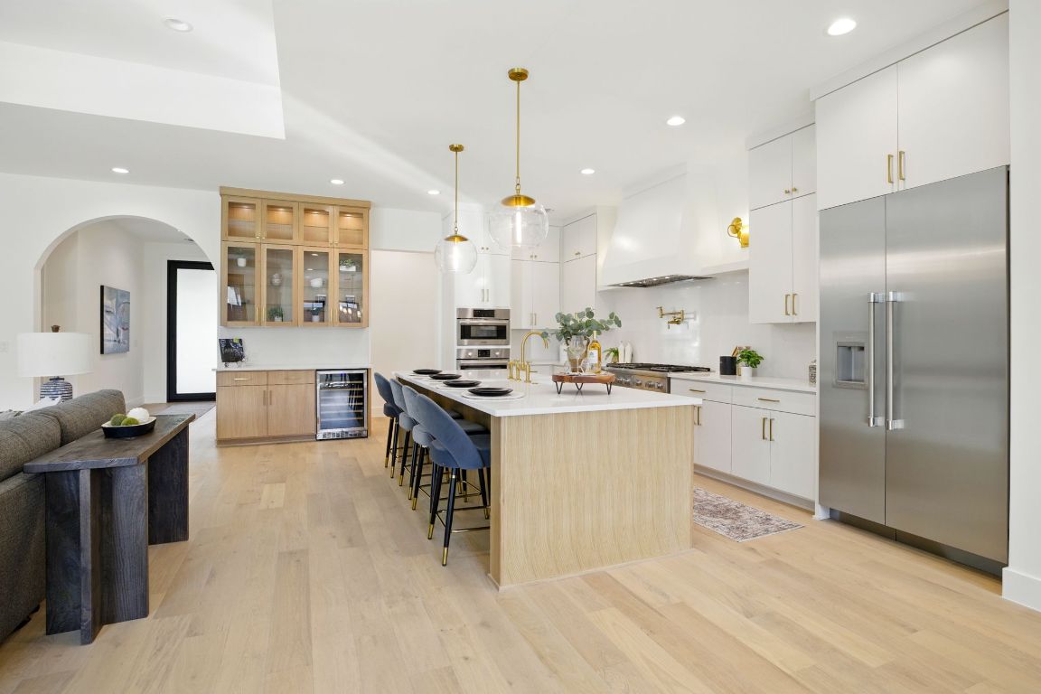 7009 Daugherty Street Austin, TX 78757 - Photo 11 of 33 a kitchen with white cabinets and stainless steel appliances