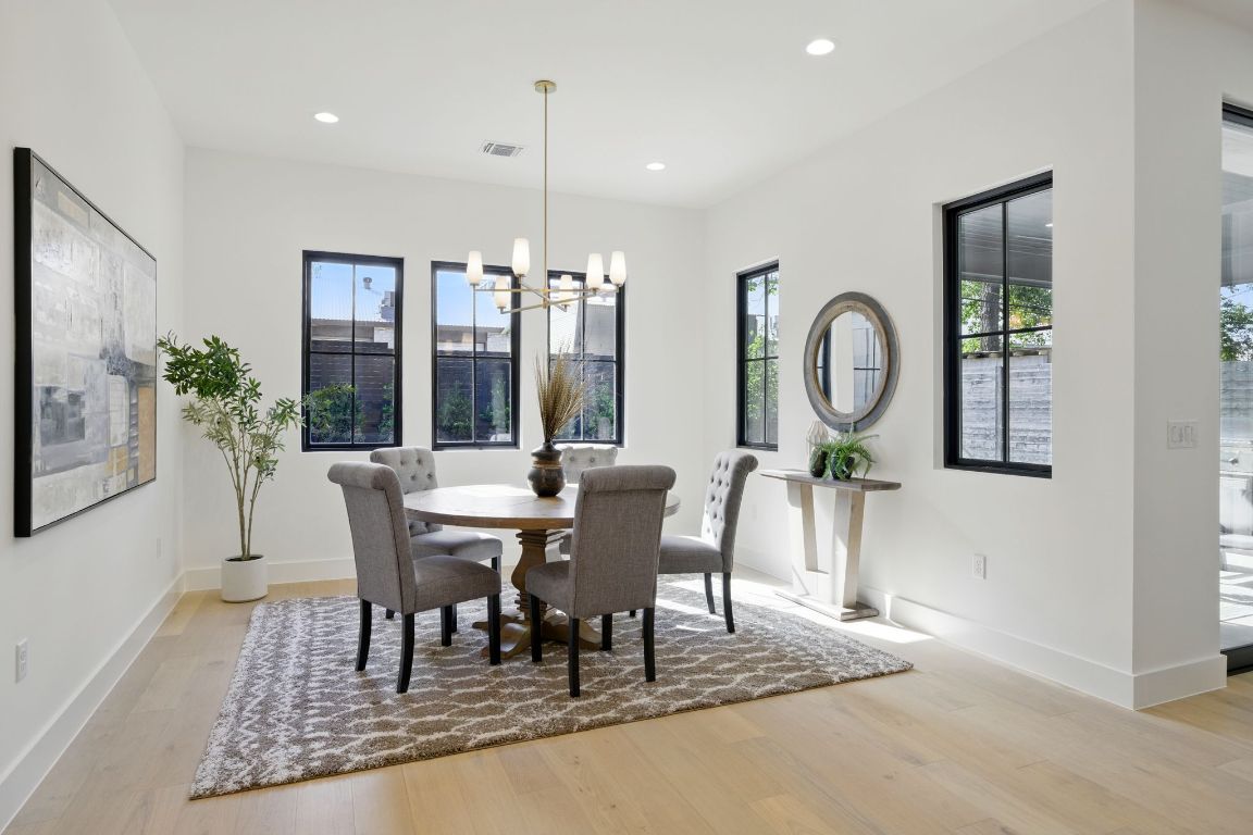 7009 Daugherty Street Austin, TX 78757 - Photo 13 of 33 a view of a dining room with furniture window and wooden floor