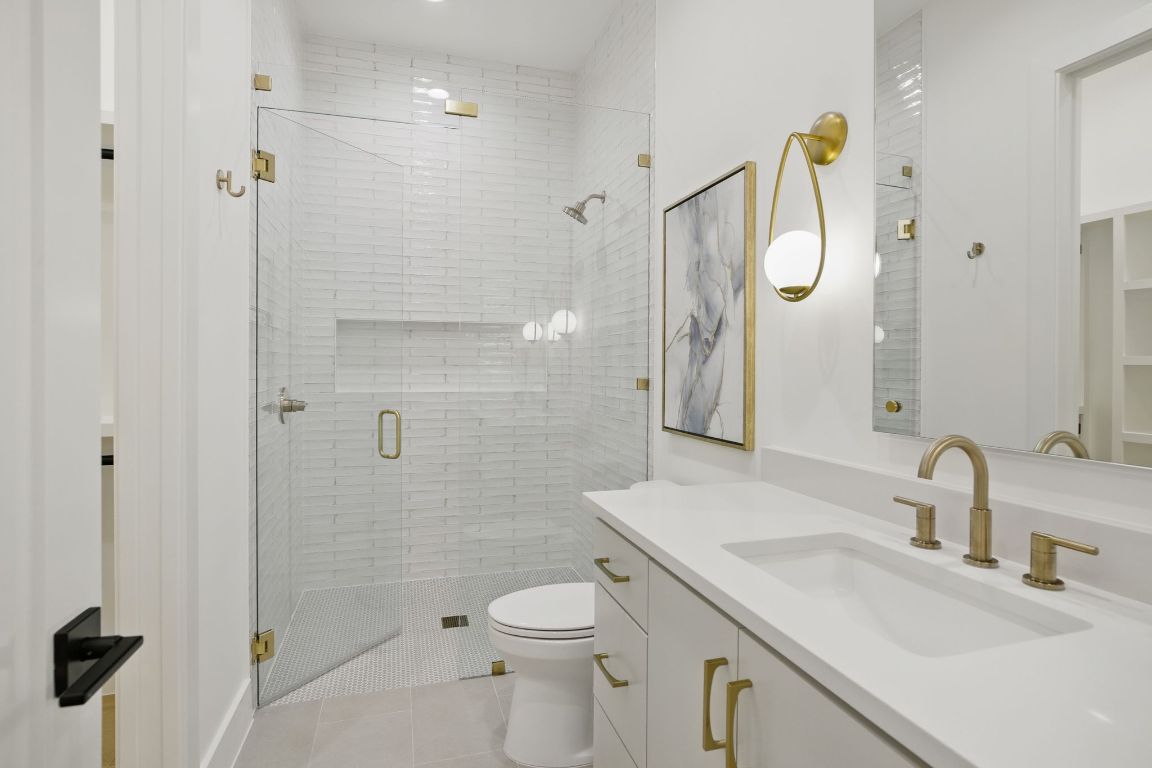 7009 Daugherty Street Austin, TX 78757 - Photo 23 of 33 a bathroom with a sink a toilet and shower