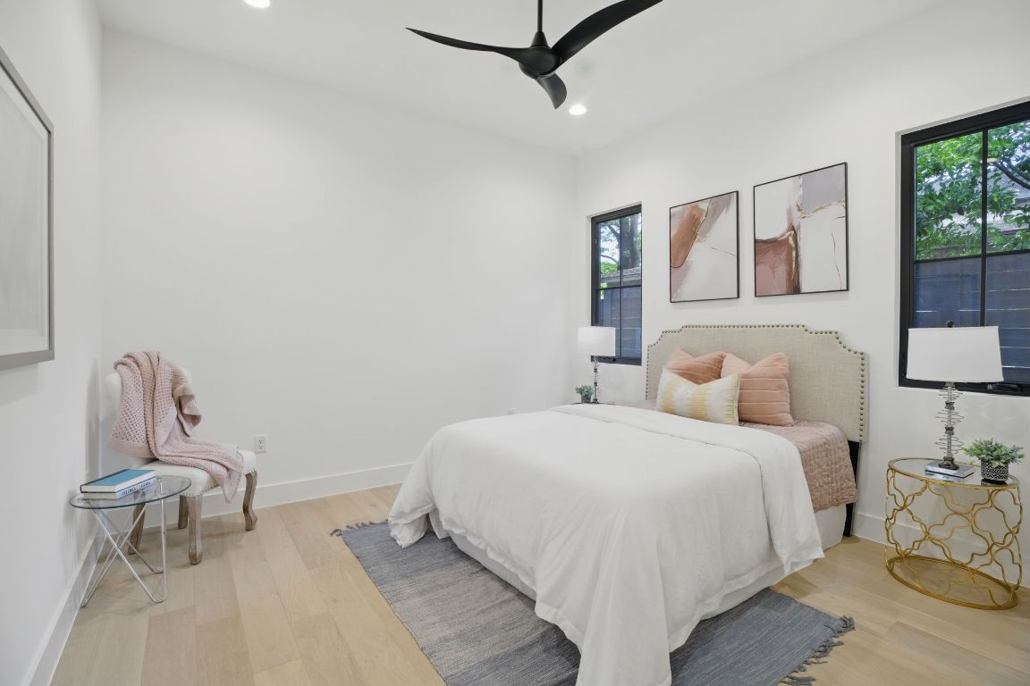 7009 Daugherty Street Austin, TX 78757 - Photo 24 of 33 a bedroom with a bed a table and painting