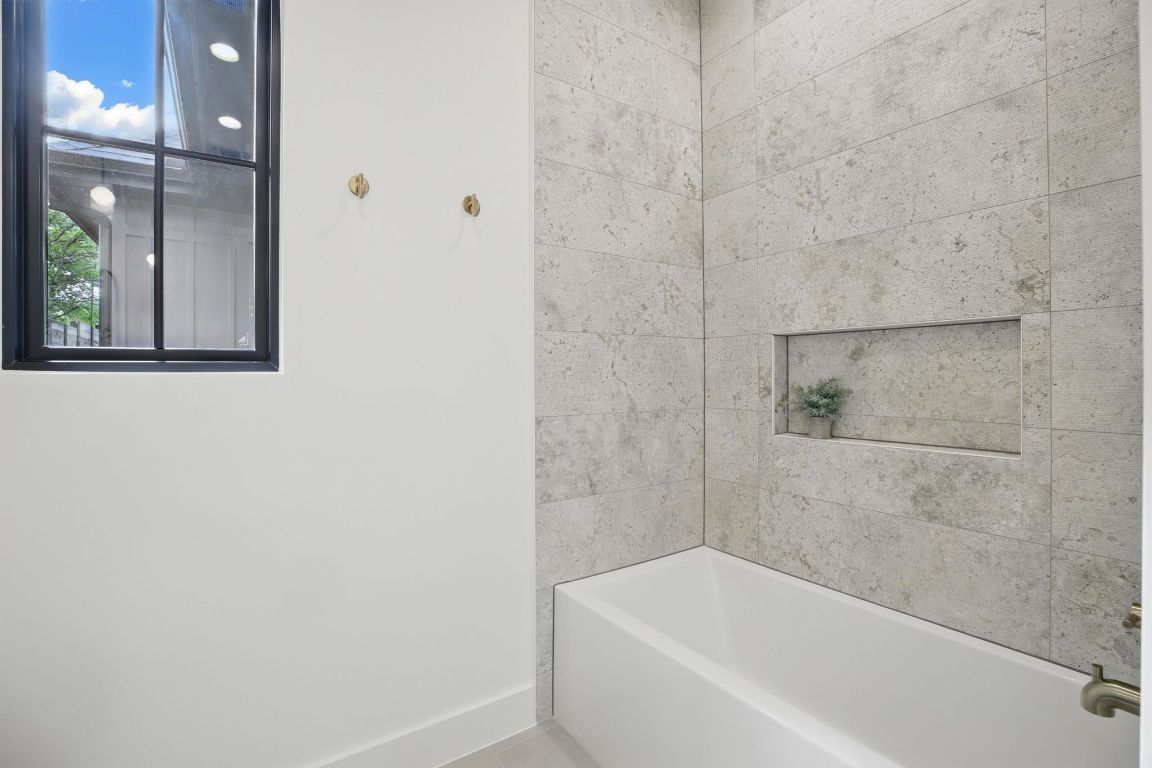 7009 Daugherty Street Austin, TX 78757 - Photo 26 of 33 a bathroom with a bathtub