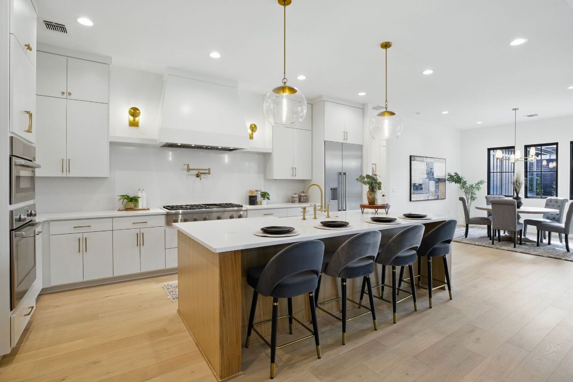 7009 Daugherty Street Austin, TX 78757 - Photo 5 of 33 a large kitchen with cabinets chairs and wooden floor