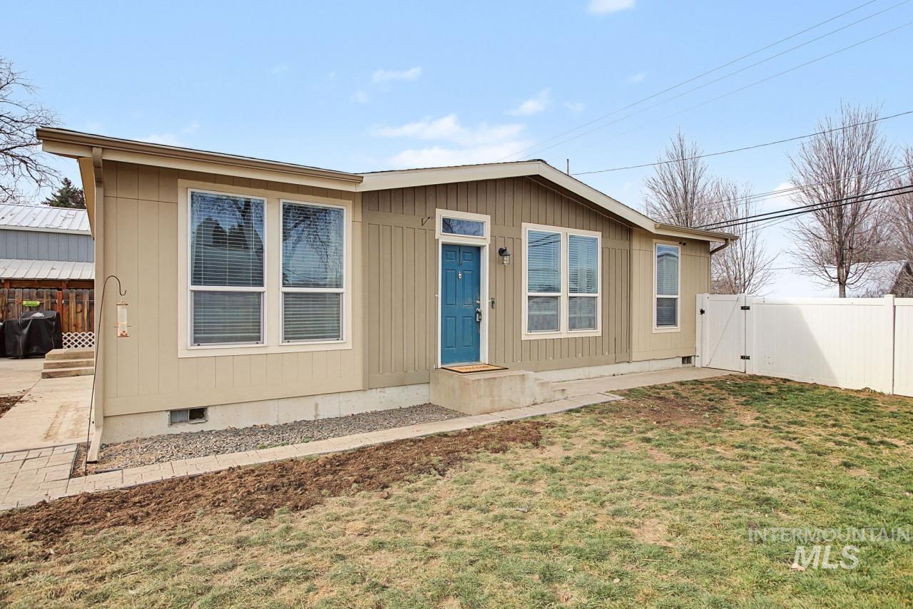 Manufactured / mobile home with crawl space, a gate, a fenced backyard, and a patio