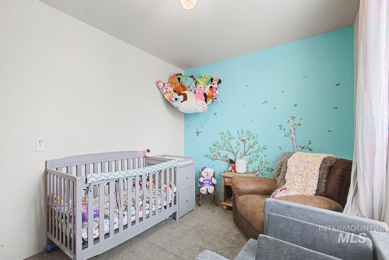 1224 1/2 Burrell Avenue Lewiston, ID 83501 - Photo 14 of 28 Bedroom with a crib and carpet flooring