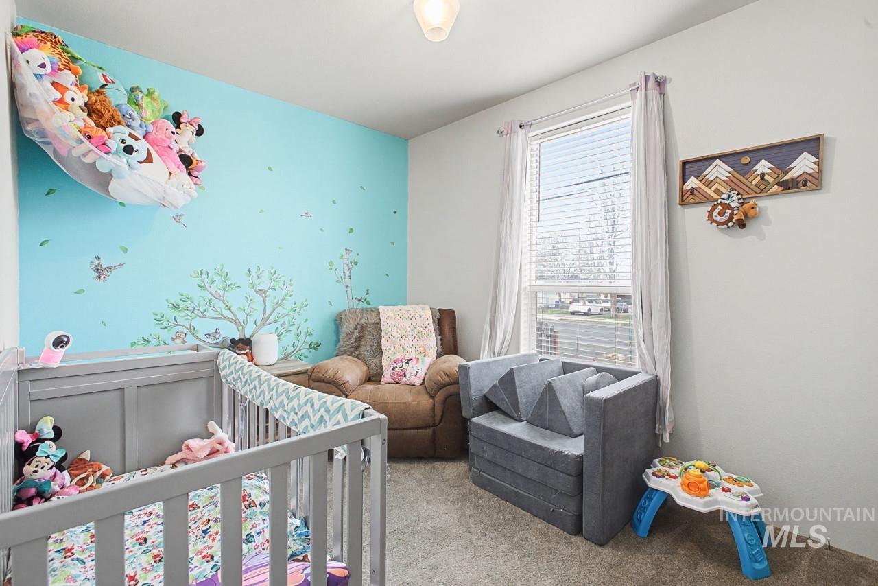 1224 1/2 Burrell Avenue Lewiston, ID 83501 - Photo 19 of 28 Carpeted bedroom with a crib and an accent wall