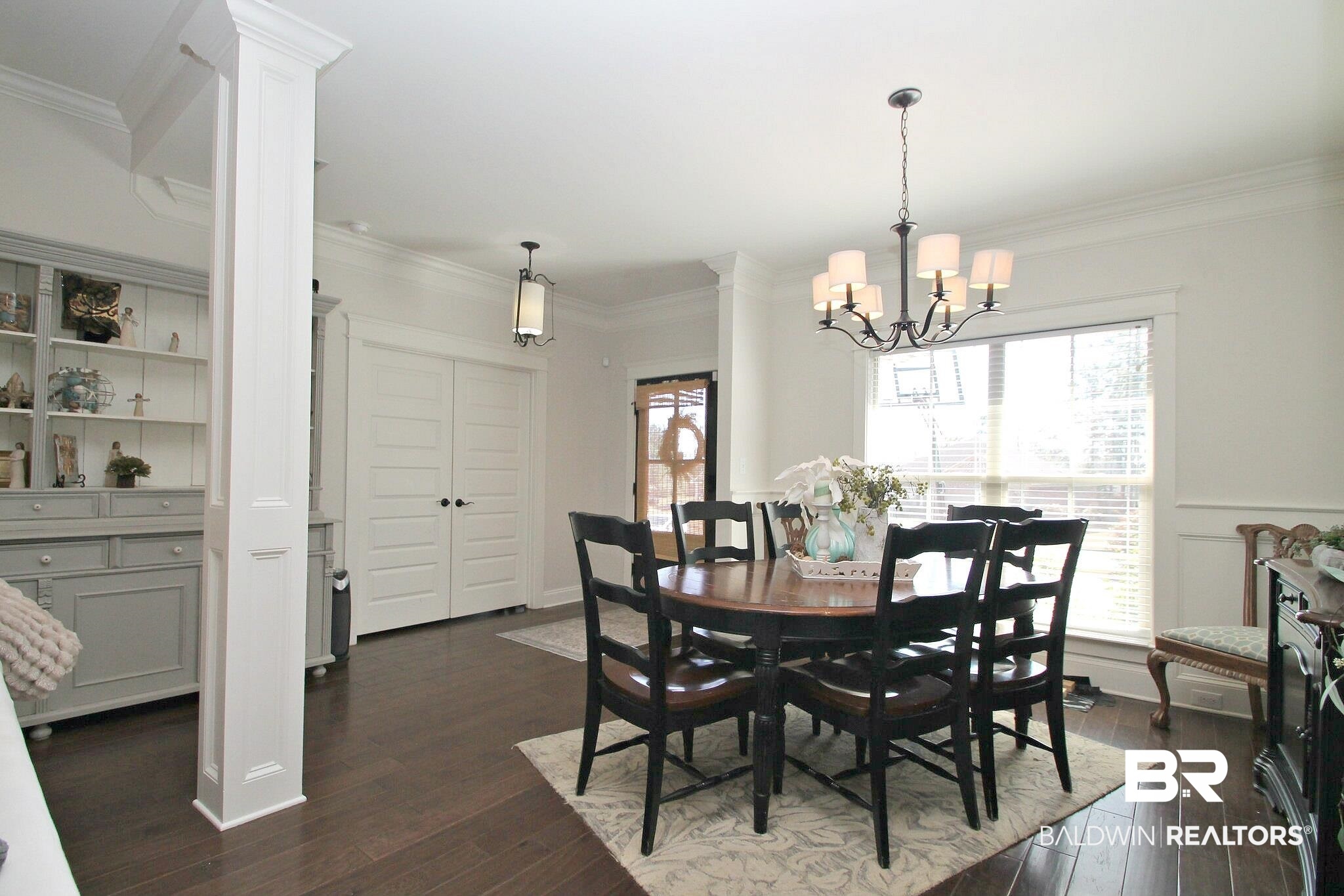 30232 Persimmon Drive Daphne, AL 36527 - Photo 3 of 27 Dining area featuring ornamental molding, dark wood finished floors, and a notable chandelier