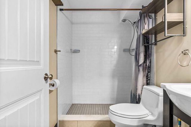 a bathroom with a toilet and a shower