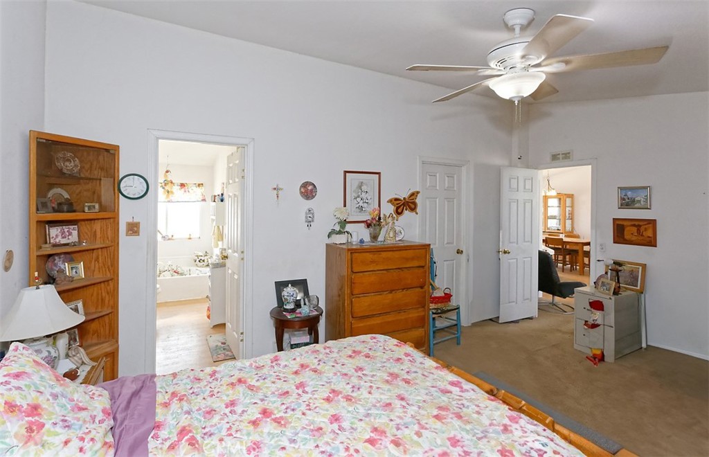 1895 Barkley Ranch Road Pinon Hills, CA 92372 - Photo 12 of 31 a bedroom with a bed and a chandelier