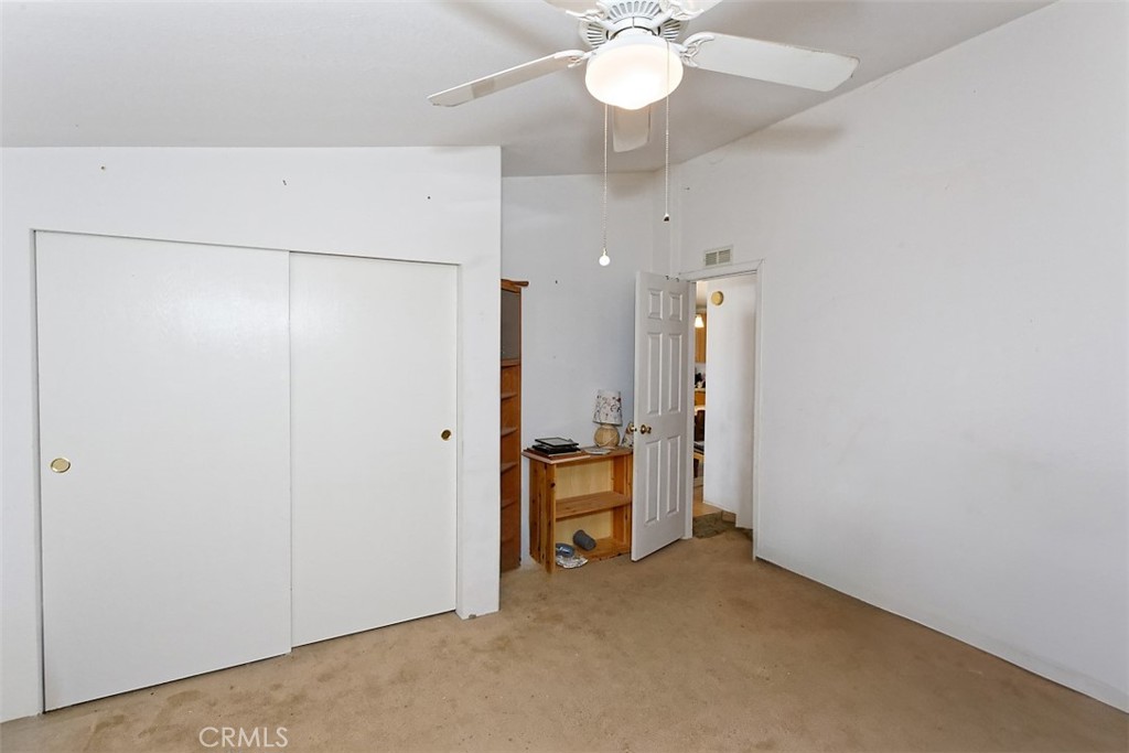 1895 Barkley Ranch Road Pinon Hills, CA 92372 - Photo 17 of 31 an empty room with a chandelier fan and refrigerator