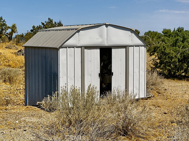 1895 Barkley Ranch Road Pinon Hills, CA 92372 - Photo 22 of 31 a front view of a house with garden