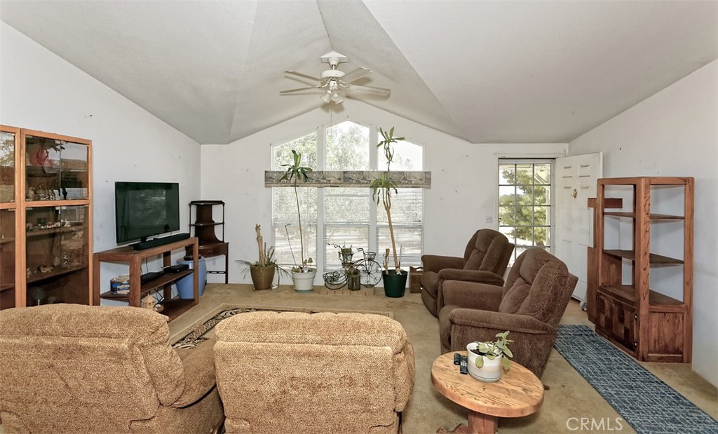 1895 Barkley Ranch Road Pinon Hills, CA 92372 - Photo 6 of 31 a living room with furniture a flat screen tv and a large window