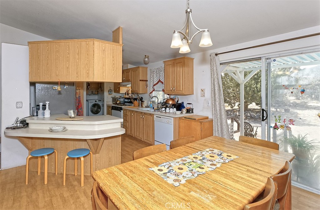 1895 Barkley Ranch Road Pinon Hills, CA 92372 - Photo 8 of 31 a kitchen with a table chairs and a wooden floor
