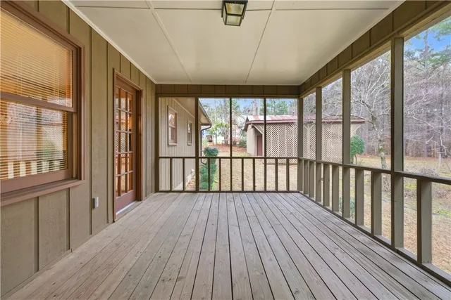 a view of a room with wooden floor and city view