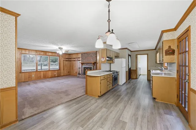 a view of a kitchen with furniture and wooden floor