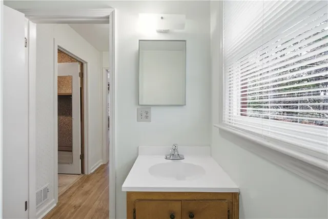 a bathroom with a sink a vanity and a window