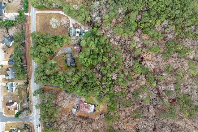 an aerial view of a house with a yard