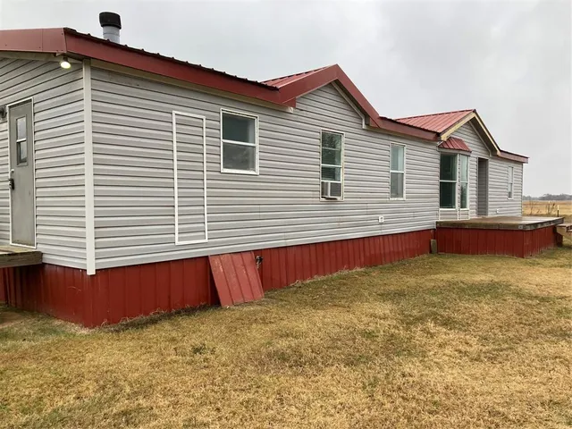 a view of a house with a backyard and a yard