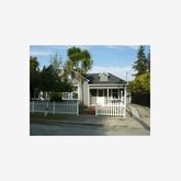 a balcony with a bench and potted plants