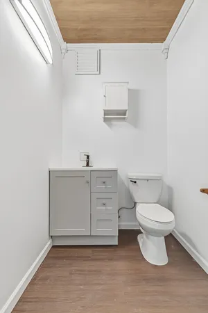 a bathroom with a sink a toilet and a mirror