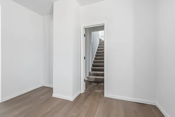 a view of a room with wooden floor