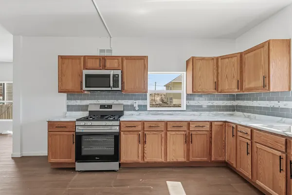 a kitchen with a sink and a stove top oven