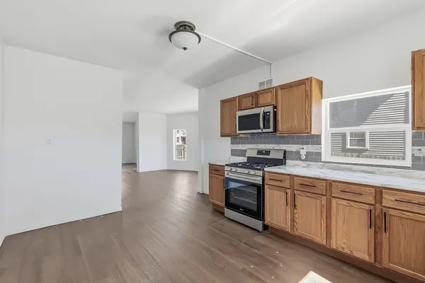 a kitchen with sink a microwave and cabinets