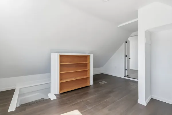 a view of an empty room and fire place