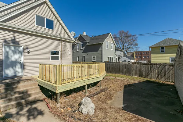 a view of a house with a wooden deck