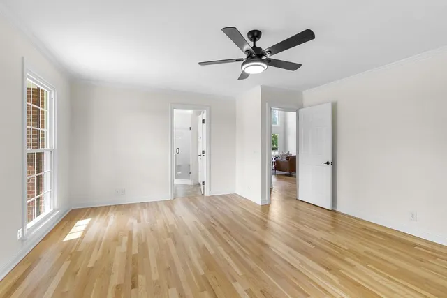 a bathroom with a granite countertop sink a mirror and shower