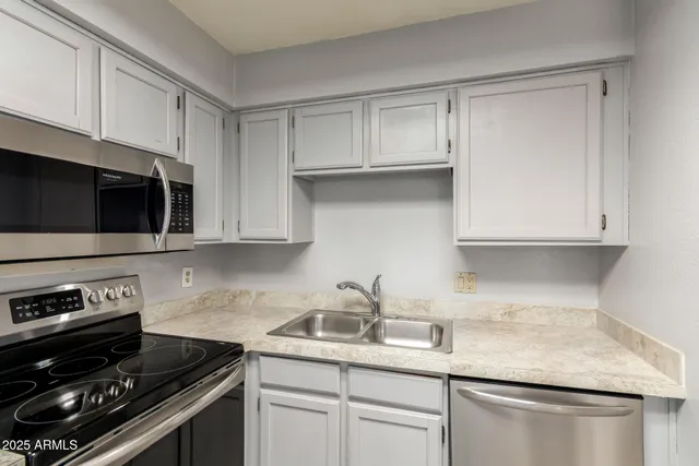 a view of a kitchen with granite countertop cabinets and a fireplace