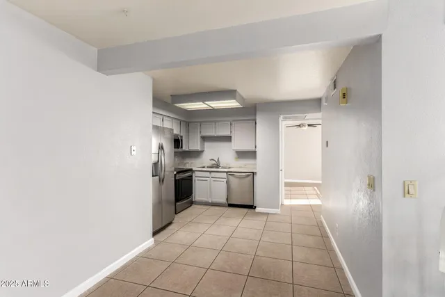 a view of an empty room with a fireplace and a window