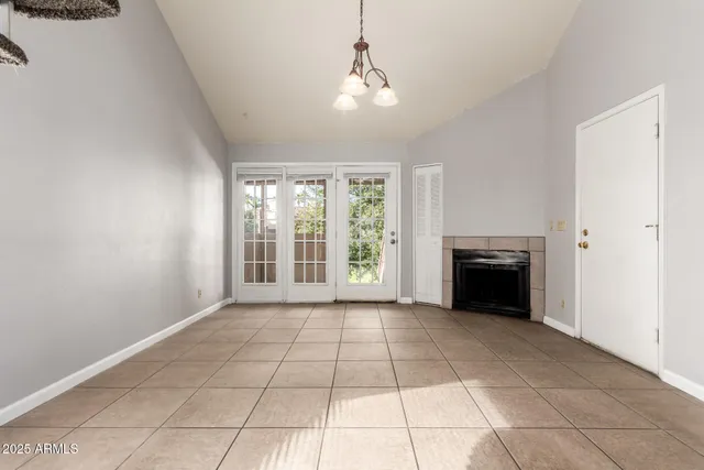 a view of an empty room with a kitchen