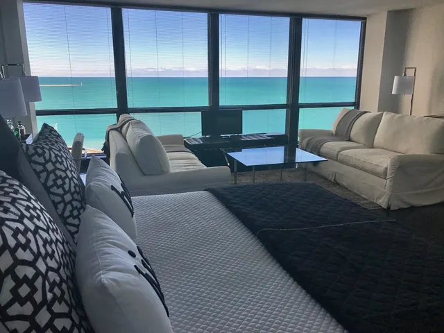 a living room with furniture and floor to ceiling window