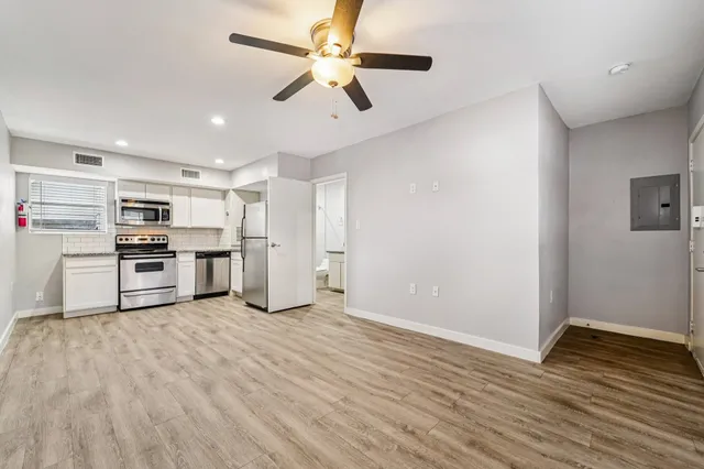 a kitchen with stainless steel appliances a refrigerator and a stove top oven