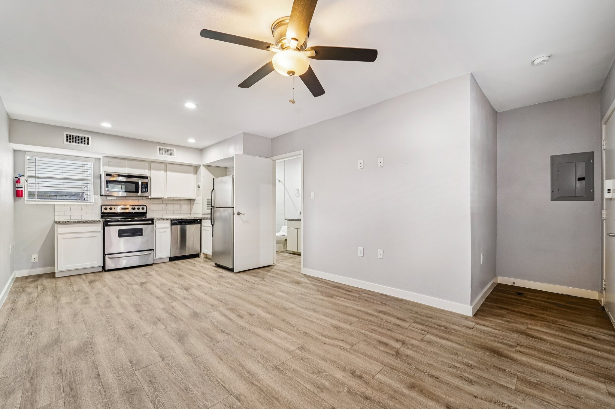 a kitchen with stainless steel appliances a refrigerator and a stove top oven