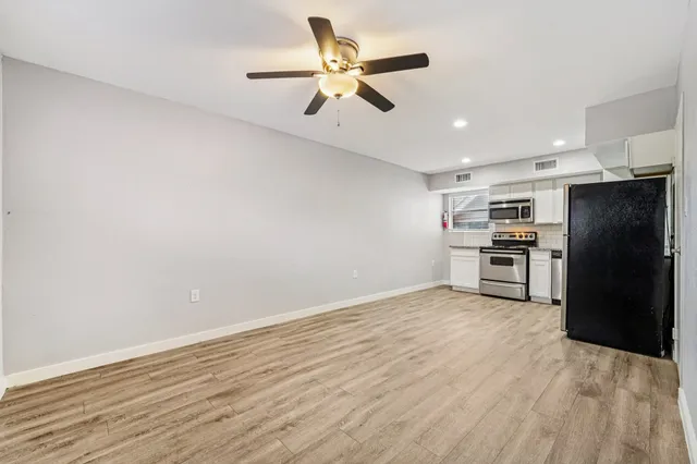 a view of kitchen with refrigerator microwave and stove