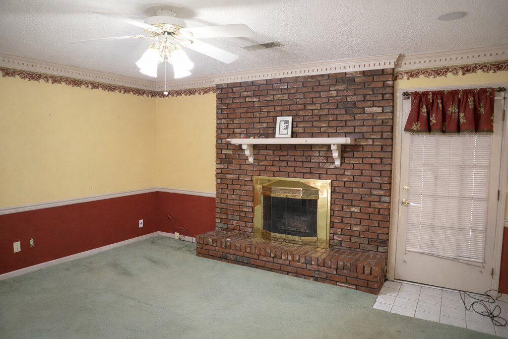 6303 Lemans Lane Columbus, GA 31909 - Photo 15 of 16 a view of fireplace with a ceiling fan and wooden floor
